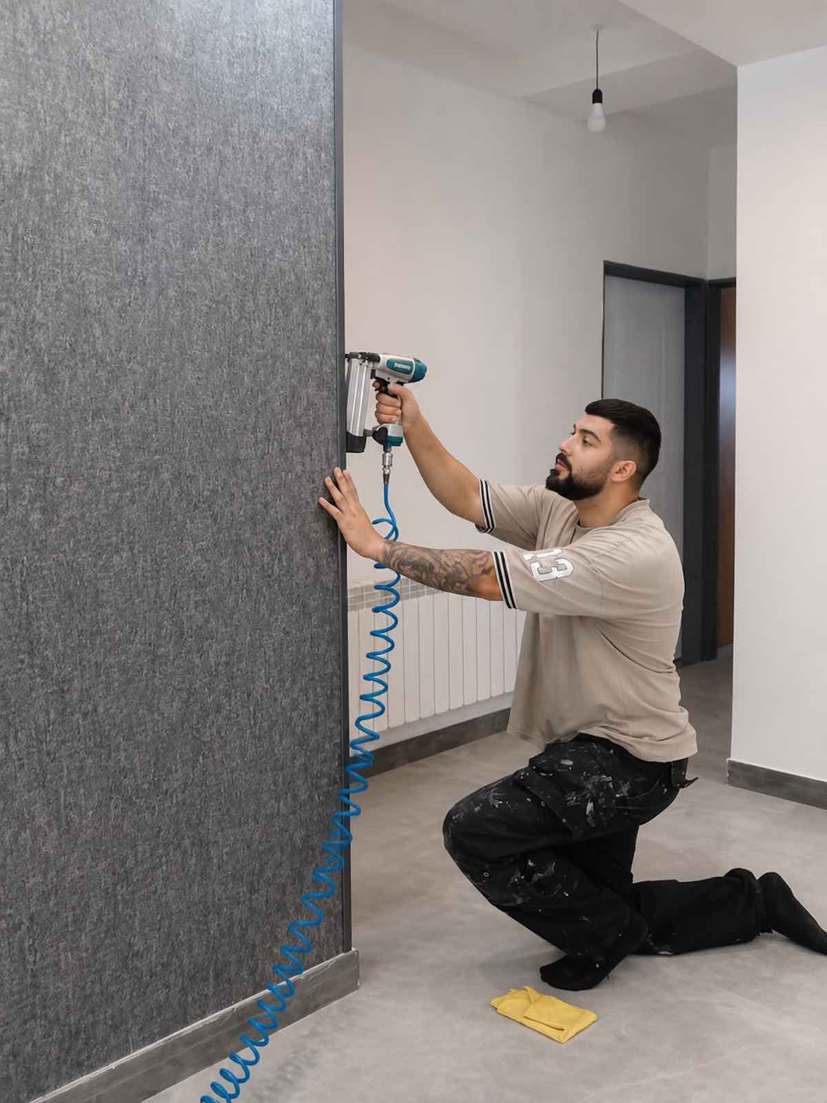 Professional wallpaper installer finishing wallpaper edges in Dubai