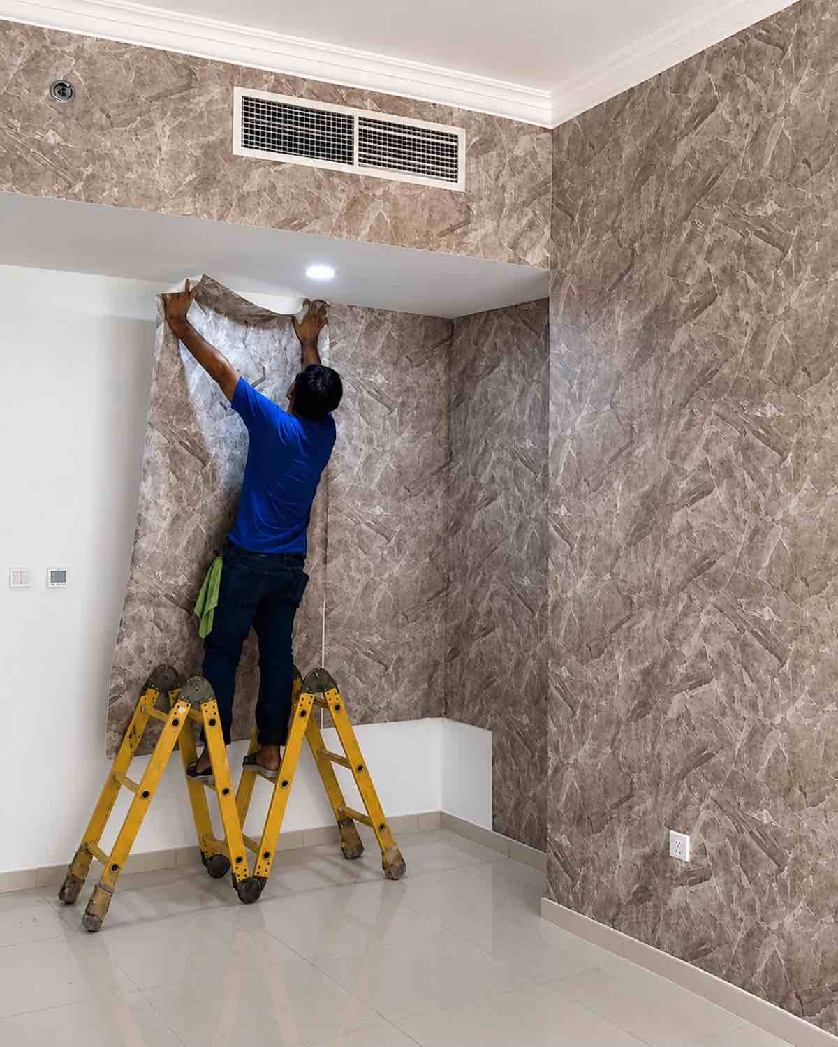 Professional marble wallpaper installation on corner wall in Al Khan, Sharjah