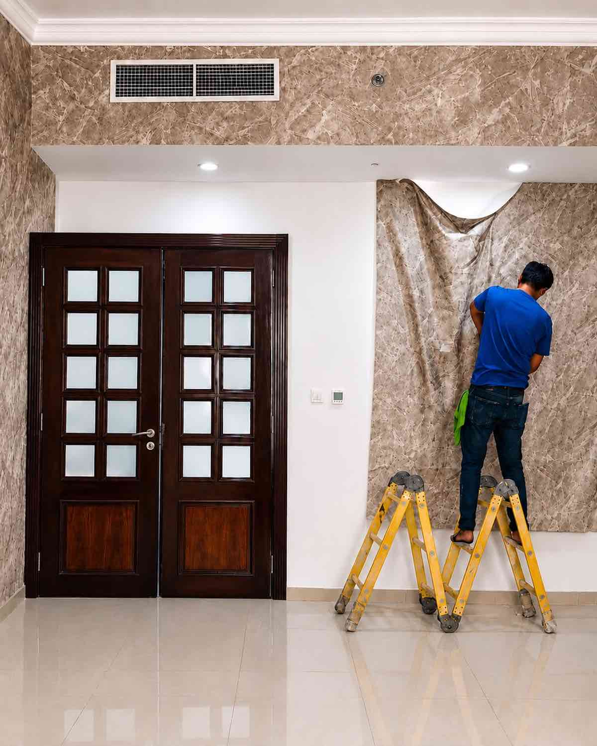 Professional wallpaper installation in Al Khan, Sharjah with marble-effect wallpaper