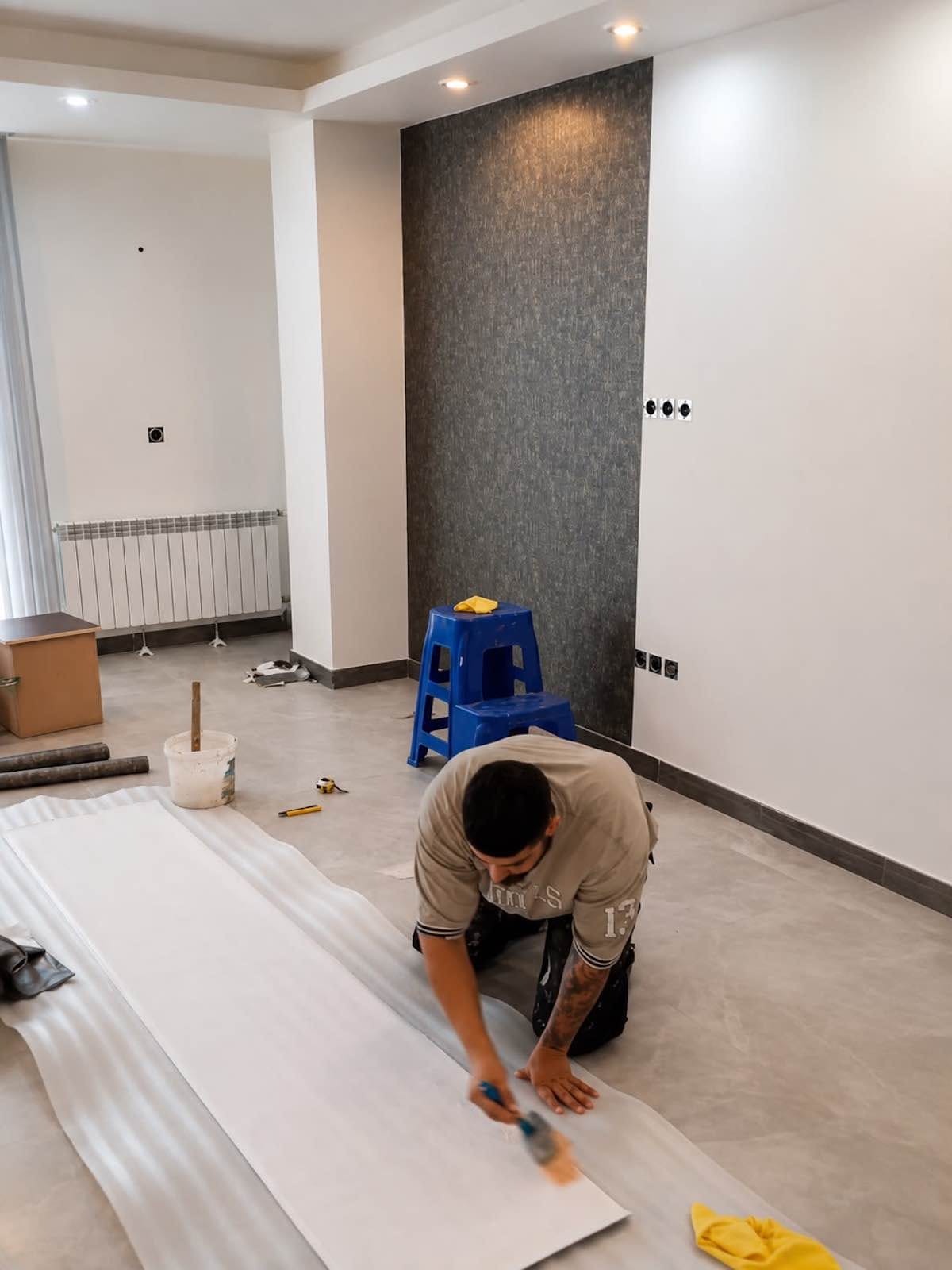 Wallpaper adhesive preparation before professional installation in Dubai