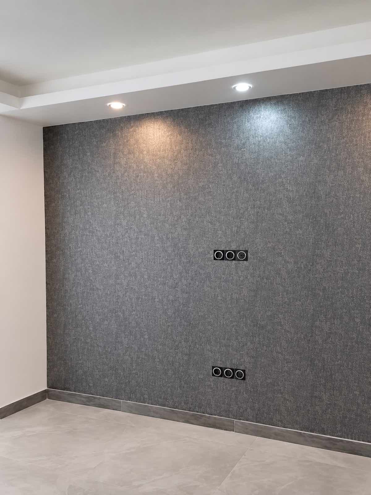 Finished wallpaper installation on a grey feature wall in Dubai